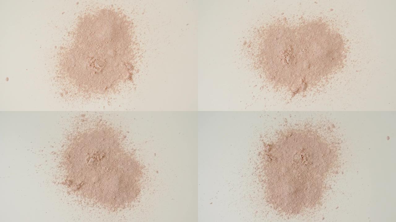 粉末，化妆品颗粒落在桌子上。沙子的动画。