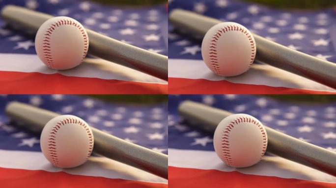 白色皮球和棒球棒躺在美国美国国旗上，特写