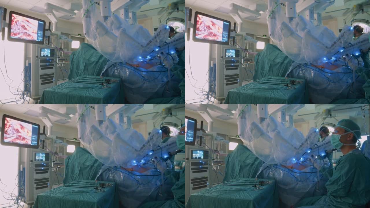 在护士工作时，外科医生在使用医疗机器人进行腹腔镜手术时看着监护仪。特写