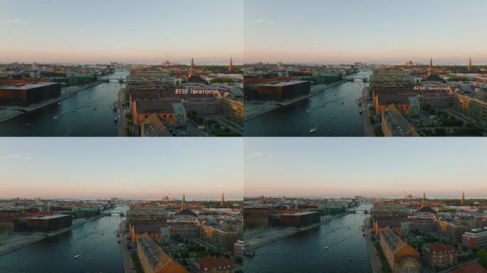 日落时海滨城市发展的鸟瞰图。向后揭示现代和经典砖砌建筑的混合体。丹麦哥本哈根