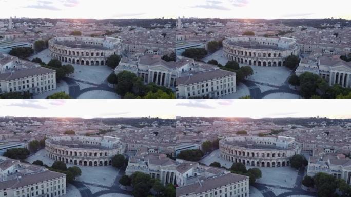 日落时尼姆旧罗马圆形剧场的空中盘旋视图