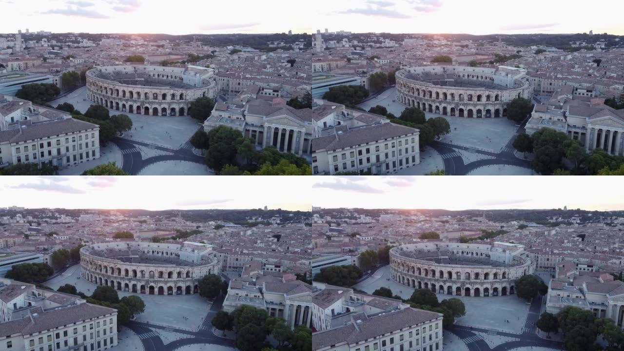 日落时尼姆旧罗马圆形剧场的空中盘旋视图