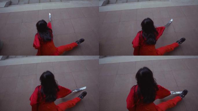 一名中国妇女在与大师练习时将银剑画在地上