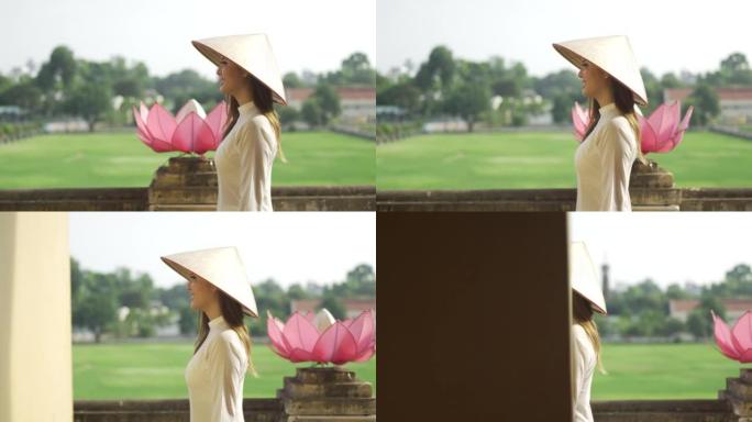 穿着传统服装和圆锥形帽子的4k越南妇女走在唐龙帝国城堡