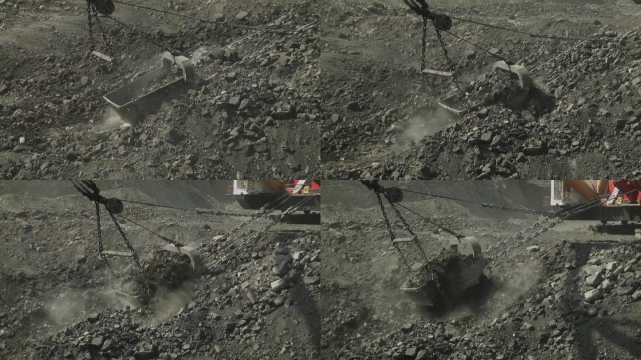 带有巨型铲斗的采石场行走挖掘机清除了露天矿中的煤层。燃料工业