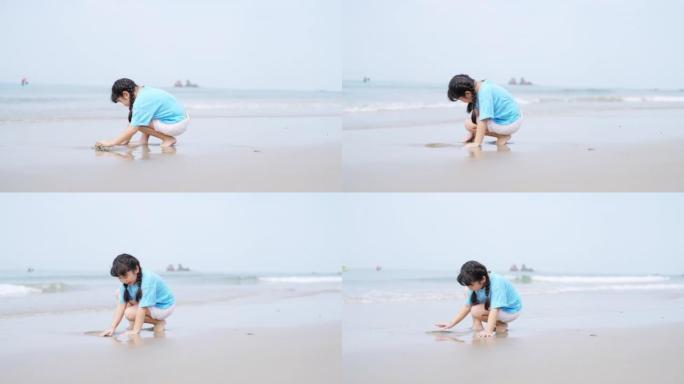 4k亚洲小女孩在夏日晴天在热带海滩上散步和玩耍。