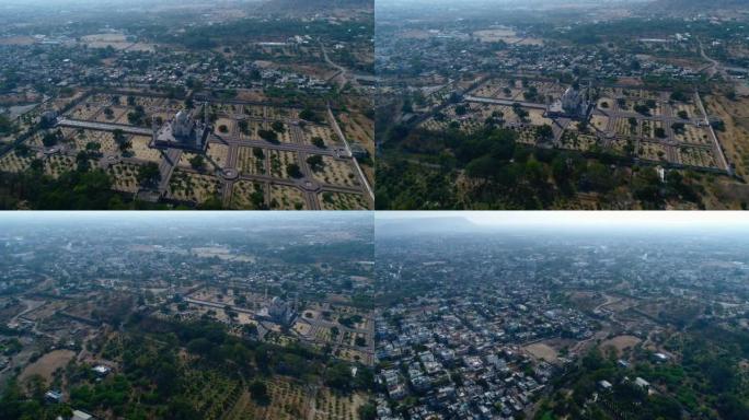 空中拍摄城市建筑物附近的大理石陵墓，背景为山丘