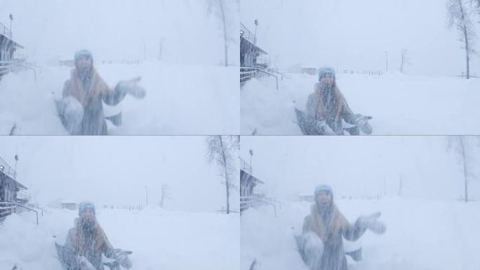 女人笑着在雪中扔雪。一个女人在冬天扔雪。倒车视频。广角围棋专业版