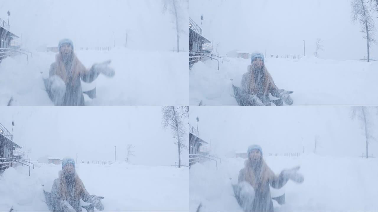 女人笑着在雪中扔雪。一个女人在冬天扔雪。倒车视频。广角围棋专业版