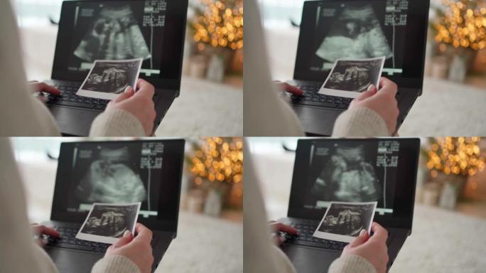 一名孕妇在笔记本电脑上观看未来婴儿超声波的视频。期待孩子，母亲，幸福，怀孕，圣诞节，奇迹，