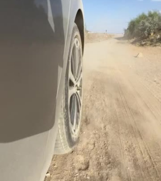 Tire of a car driving on gravel road