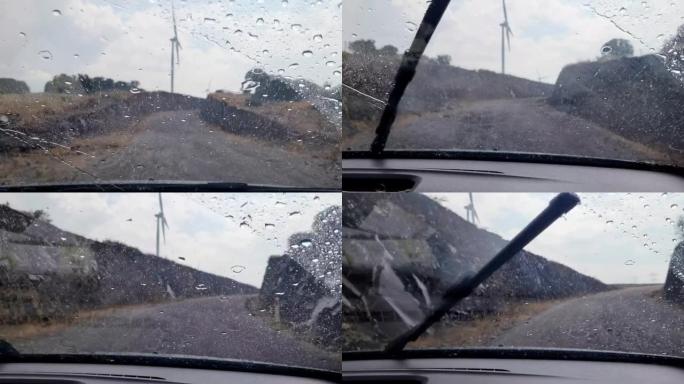 汽车挡风玻璃刮水器期间的雨天视图雨滴在车内滑落