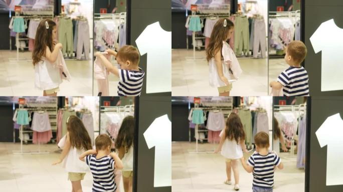 商店里的两个小孩在购物中心的服装店里为自己挑选东西。商店里的人选择时尚的衣服。孩子们在没有父母监督的