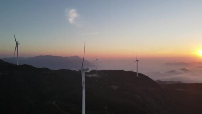 Sunrise, sea of clouds, mountains and wind turbine