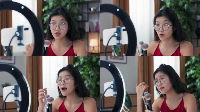 扎着马尾辫的女人录制了有关如何选择合适化妆刷的简短教学视频。女孩在社交媒体上创建美容内容