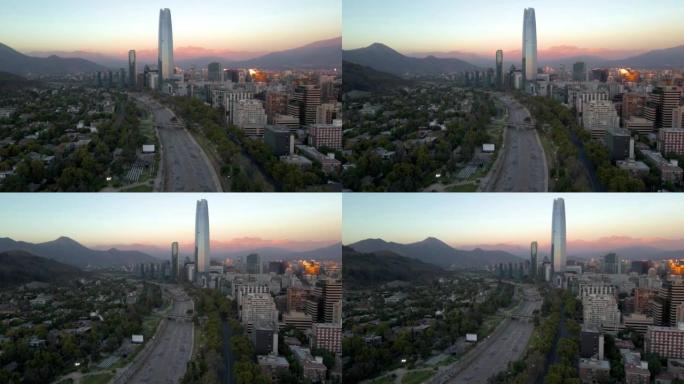 智利圣地亚哥普罗维登西亚蓝色小时背景下的露天免费电影院、马波乔河、桑哈坦摩天大楼和山丘的空中视差