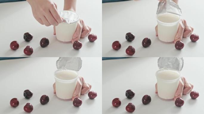 4k视频，打开自制酸奶塑料盖和铝盖。打开塑料罐纯希腊酸奶。商店买了天然酸奶即食。健康休闲食品早餐配新