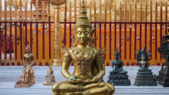 在泰国清迈的土素贴寺，佛教信徒们在主塔周围散步，前景是一个看起来宁静的佛像，放大