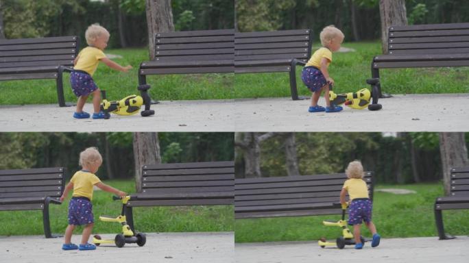 快乐的孩子在户外学习为年幼的孩子骑平衡自行车，1.5岁的孩子在夏天在公园里为幼儿玩脚踏车。
