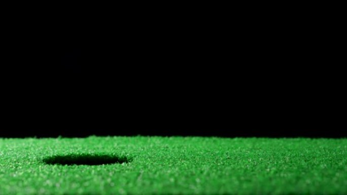 Golf ball rolling down the hole