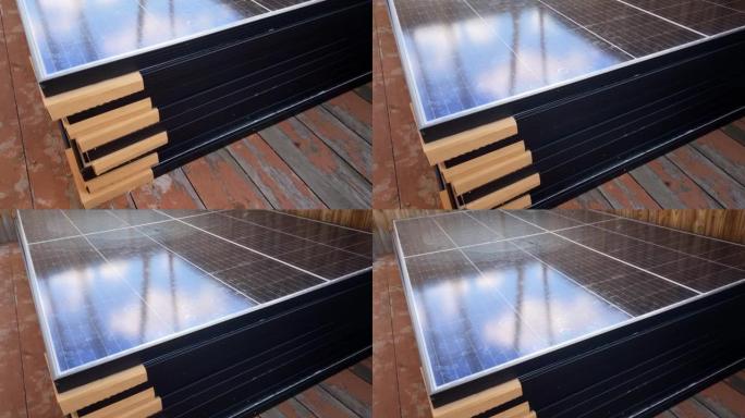 装运并准备安装的高堆光伏太阳能电池板堆叠在旧木地板上。自制