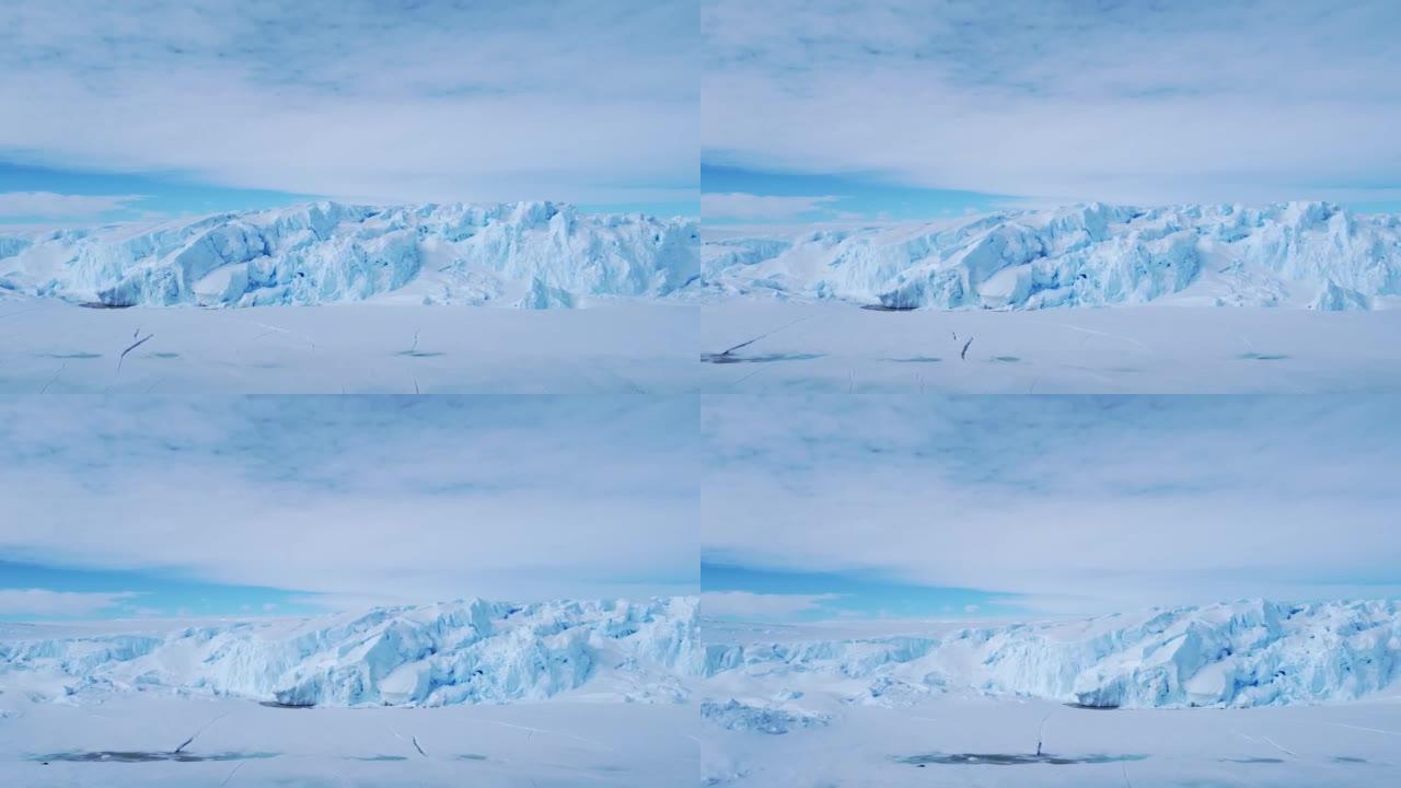 积雪覆盖的南极地表鸟瞰图飞行。
