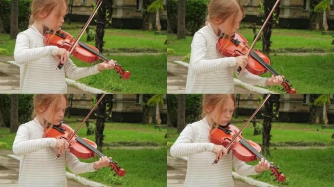 一个年轻美丽的高加索女孩拉小提琴
