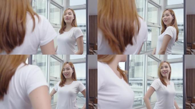 自信的年轻亚洲女性看着自己的身体倒影照镜子