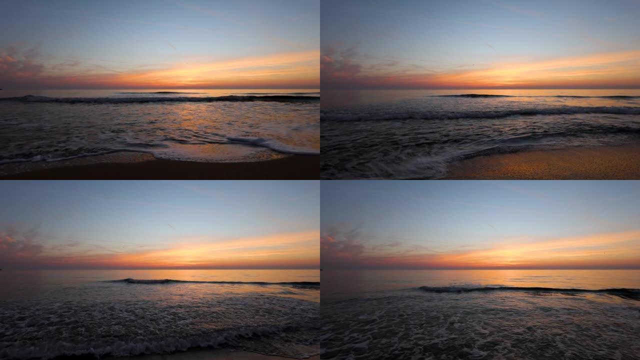 日落时波浪形大海的美丽景色