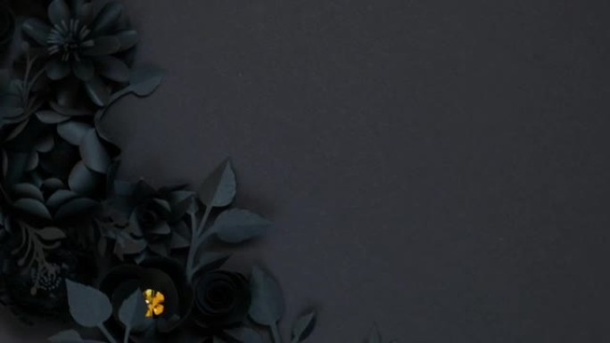黑色背景上的黑色纸花。从纸上剪下。