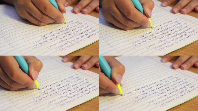 学生的手用英语写笔记本，特写。