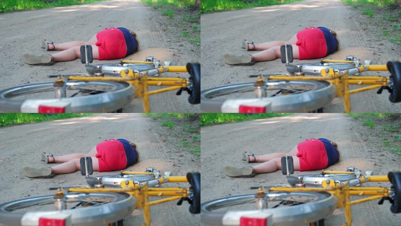 年轻受伤的昏迷高加索女孩骑自行车者被汽车撞到后躺在地面乡村道路上