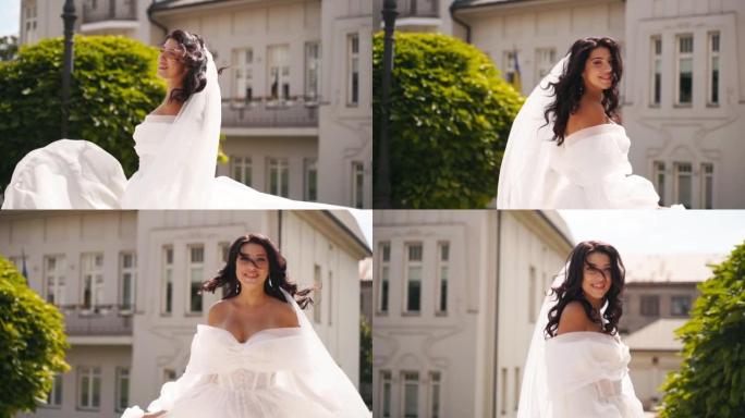 漂亮的新娘穿着长长的通风面纱，优雅的白色连衣裙在豪华宫殿花园的婚礼当天在空气中飘扬。穿着神话般的礼服