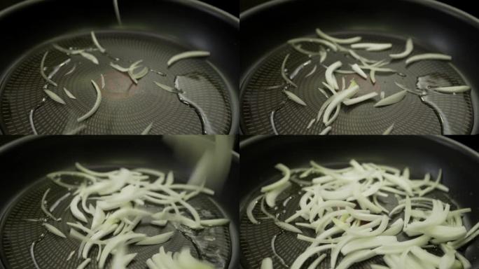 在平底锅上油炸的洋葱片特写镜头。
