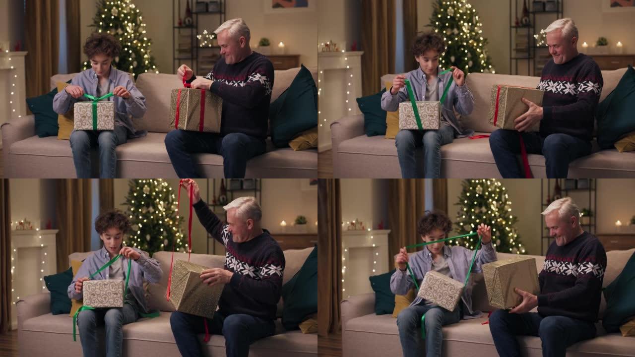 在圣诞晚会上，父子俩交换了礼物，微笑着打开包装。他们解开礼物上的绿色和红色丝带。儿子有深色卷发，父亲