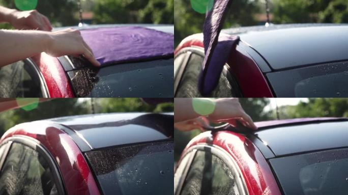 a man wipes the car body after washing.