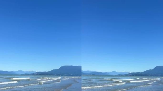 沉船海滩，塔海滩，阿卡迪亚海滩温哥华裸体海滩在太平洋上慢慢摇拍，显示小波浪形成白色条纹的温哥华岛温柔