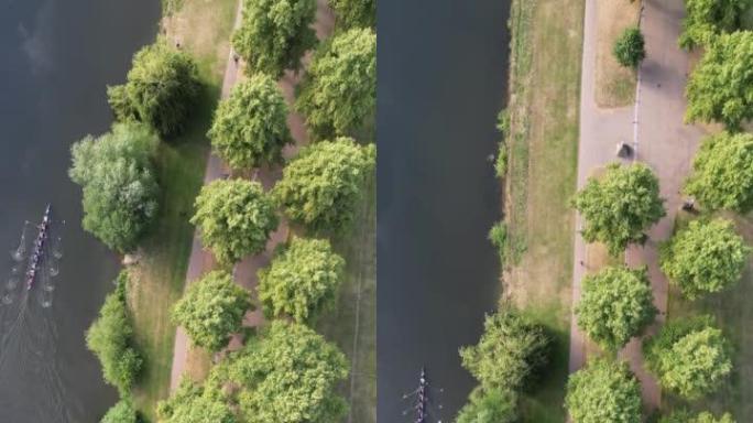 垂直视频，空中无人机俯视流经公共公园的大型内城河流。塞文河