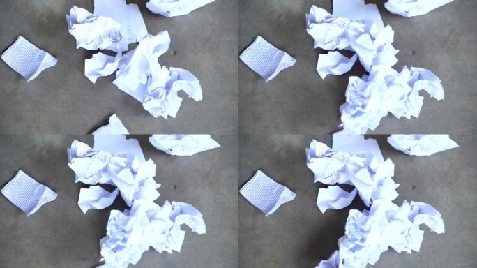 在地板上扔纸的特写镜头。
