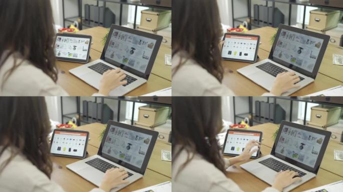 4k女商人在办公室使用笔记本电脑时使用数字平板电脑