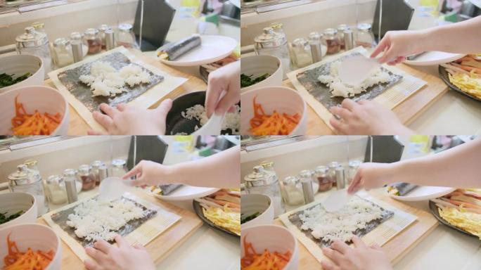 厨师手工烹饪韩国传统食谱食品制作kimbap翘曲新鲜成分海藻米粉蔬菜在家庭厨房竹卷，美味的亚洲寿司料