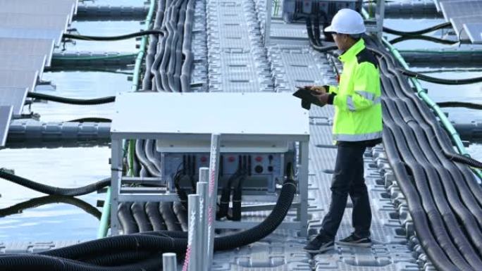 Asian engineer working at Floating solar power pla
