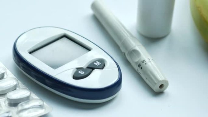 白色背景上的糖尿病测量工具和药丸的特写