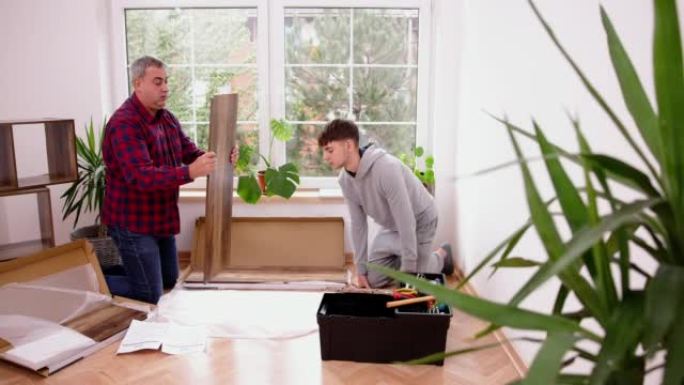 Caucasian father and son assembling shelf in the r