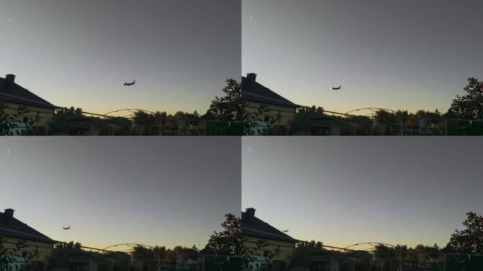 散焦视频。飞机在日落天空的乡下飞行。