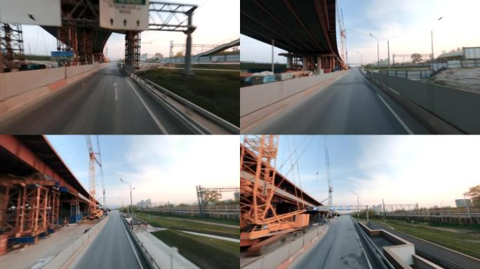 fpv无人机拍摄的快速宝马摩托车正在建设中的城市道路