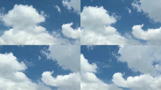 漂浮在充满活力的蓝天上的纯白云彩的延时镜头