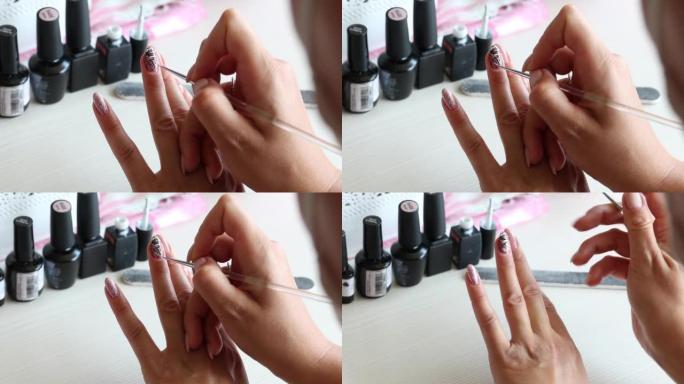 A woman applies nail polish. Does a manicure. Next