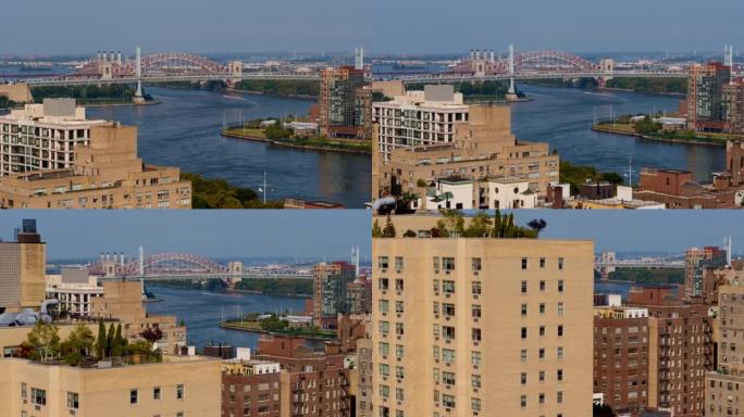 RFK桥和地狱门桥从曼哈顿上东区可以从东河远眺。具有向后下降的摄像机运动的航空视频。
