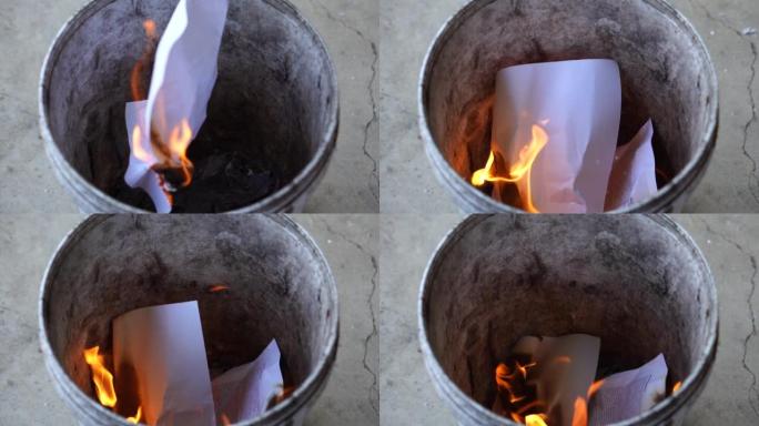 特写粉碎文件，把文件烧进垃圾桶。